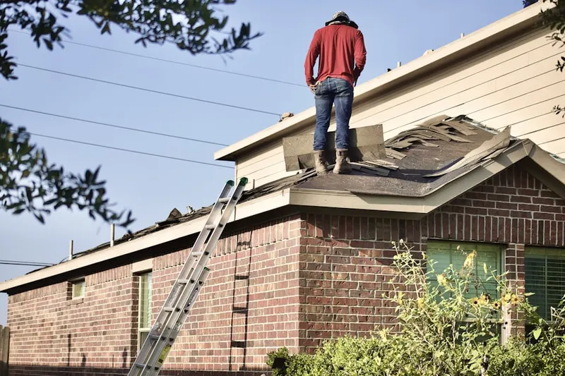 Professional roofer working on a residential roof in Crosstown